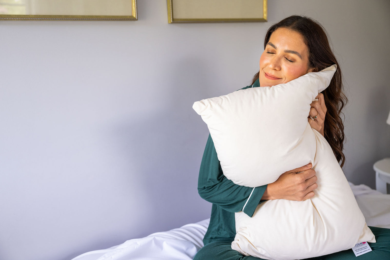 Woman Holding Down Alternative Pillow With Recycled Polyester Fill