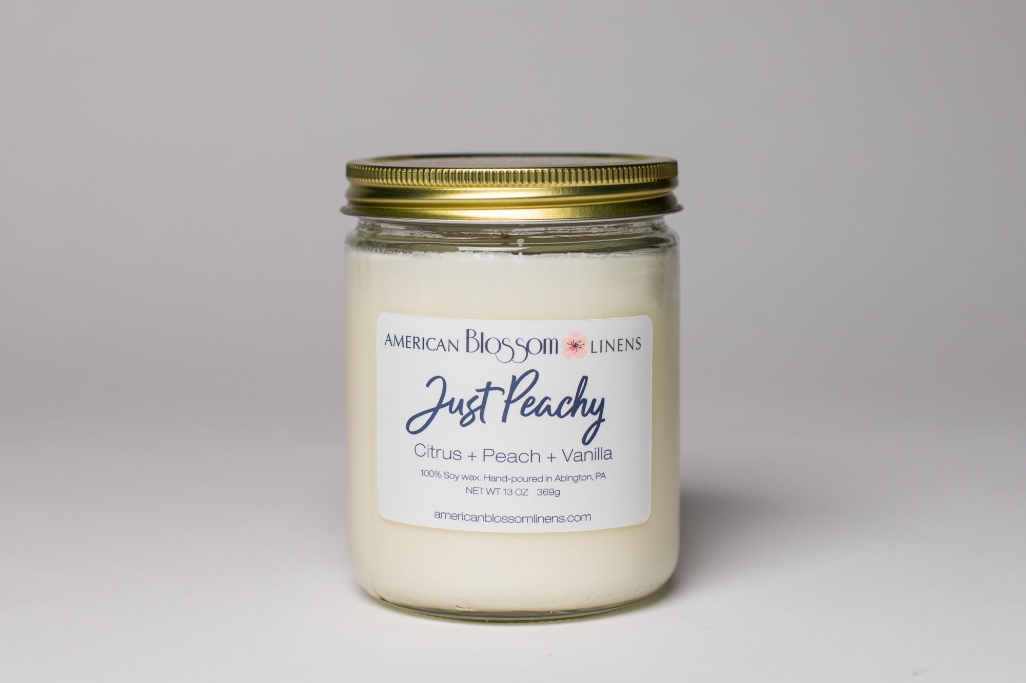Burning American Blossom Linens Just Peachy Candle 100% Soy hand poured in the USA.