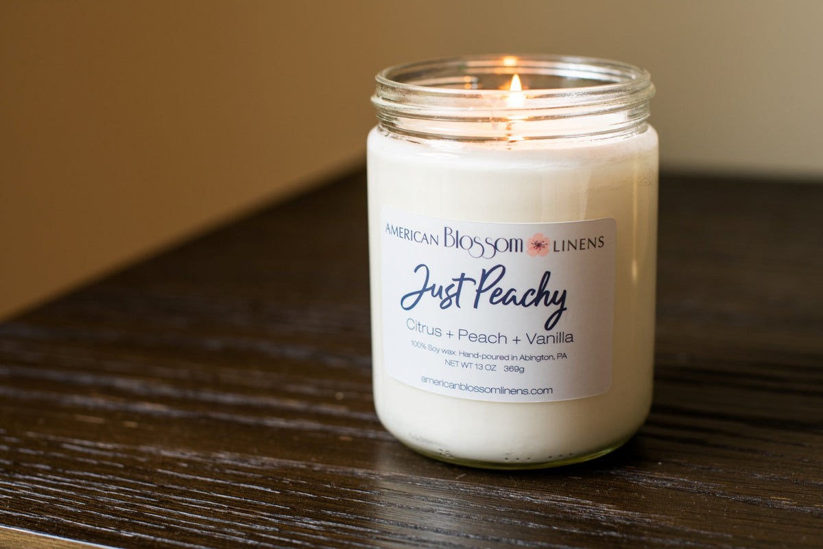 Burning American Blossom Linens Just Peachy Candle 100% Soy hand poured in the USA.