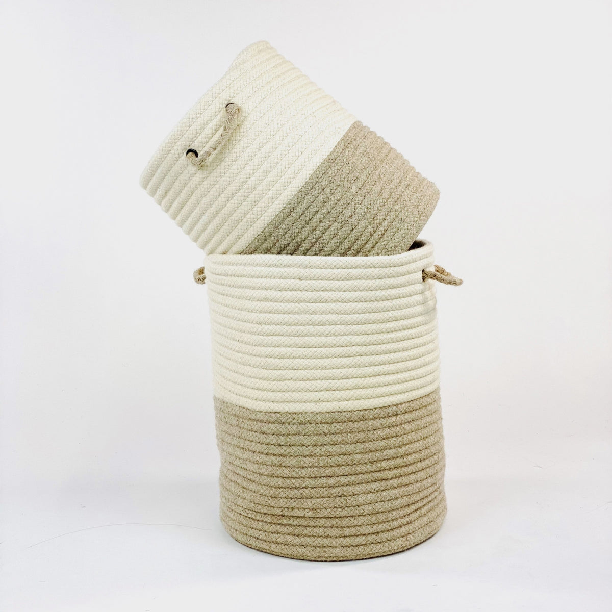 Small two tone beige American made natural wool hamper stacked in a large one.
